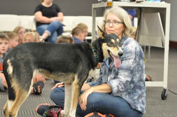 Karen Land sits with her sled dog, Noggin, Thursday during a presentation about the Iditarod race Thursday at the Crawfordsville District Public Library.