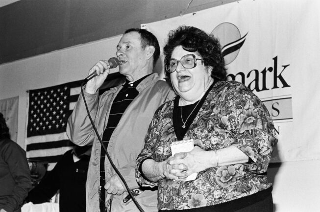 Dorothy Page laughs as Howard Farley speaks at the musher banquet in Nome during the 1989 Iditarod. B&W negatives