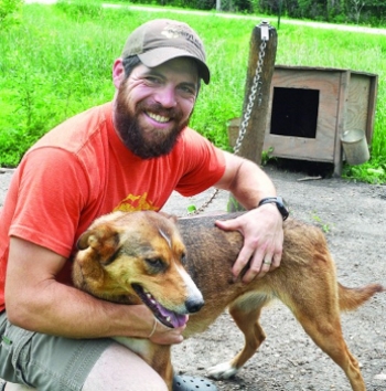 CHARLIE WARNER/BLUFF COUNTRY NEWSPAPER GROUP Damon Ramaker of rural Fountain is shown with Yentna, who is one of his lead dogs that will be mushing through the Alaskan wilderness in the Iditarod next March.