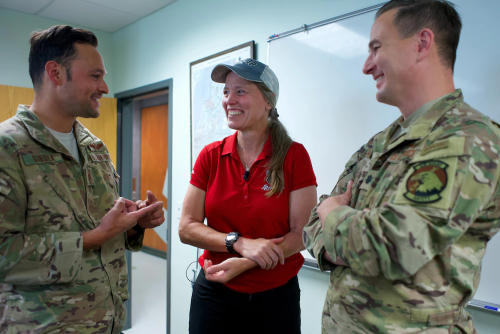 Courtesy Photo | JOINT BASE ELMENDORF-RICHARDSON, Alaska -- Alaska Air National Guardsmen of 210th Rescue Squadron, Tech. Sgt. Anthony Guedea (left) and Lt. Col. Michael Jordan, meet with Iditarod musher Aliy Zirkle June 28, 2021, at Joint Base Elmendorf-Richardson, Alaska. Guedea and Jordan were part of the team that rescued Zirkle March 9 at the Iditarod Rohn checkpoint after she suffered a head injury. (U.S. Air National Guard photo by David Bedard/Released)