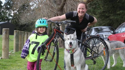 JOHN BISSET/STUFF Santia Throp, 3, races in the Southern Region Sled Dog Club competitions with her mum Angela Clark on their bicycle pulled by their huskies Zephyr and Shiva.