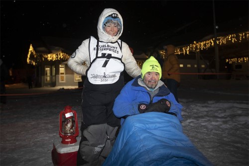 Red lantern finisher Olivia Webster poses with her grandpa, LeRoy Shank, at the finish line of the 2020 Yukon Quest in Whitehorse on Feb. 15. Shank, one of the Quest’s founders, died this month at the age of 79. (Crystal Schick/Yukon News file)