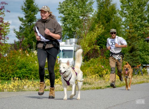 FLYING TO THE FINISH – Vico Fauveau and Sneaky Boy, front, and Ben Simard and Rye come in to the finish of the DPSAY one mile canicross Saturday at the old fire hall in Whitehorse.  Photo by Morris Prokop