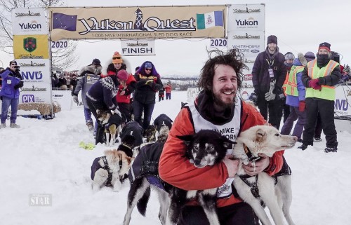 VICTORY CELEBRATION – Brent Sass celebrates a first-place finish in Whitehorse with his furry crew at the 2020 Yukon Quest. Photo by Whitehorse Star
