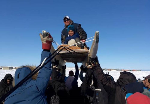 Pond Inlet musher Michael Inuarak is hoisted in the air after completing the Nunavut Quest in 2017. That year the race began in Arctic Bay and ended in Igloolik, as it would have this year, prior to the race’s cancellation to avoid the spread of COVID-19. (File photo)